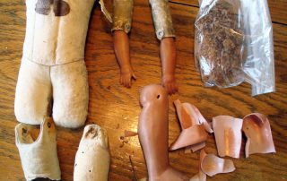 celluloid doll repair on an old leather doll body